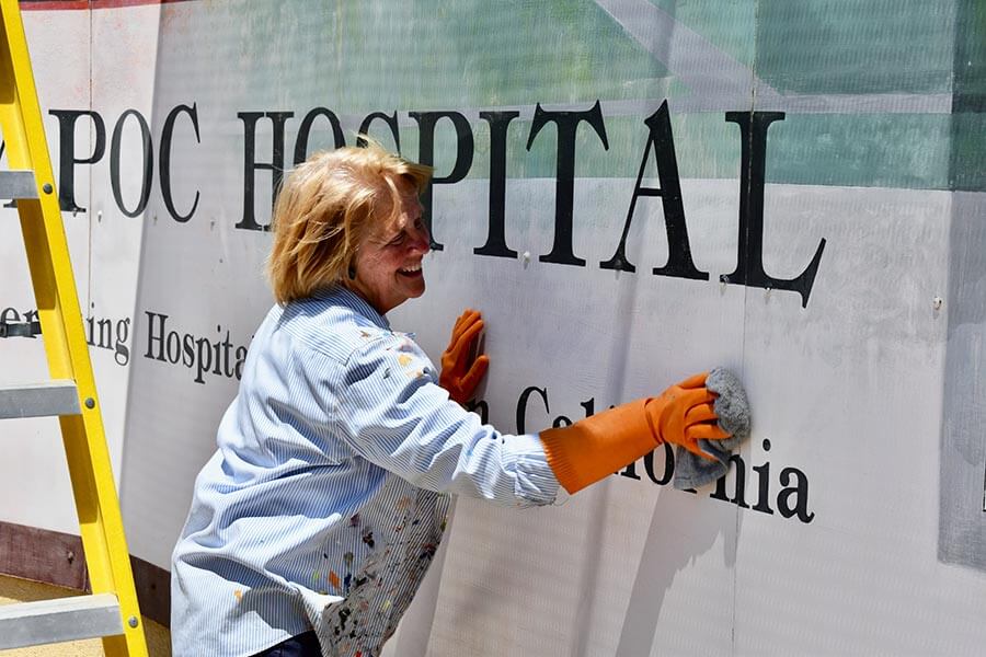 Lady cleaning a Mural