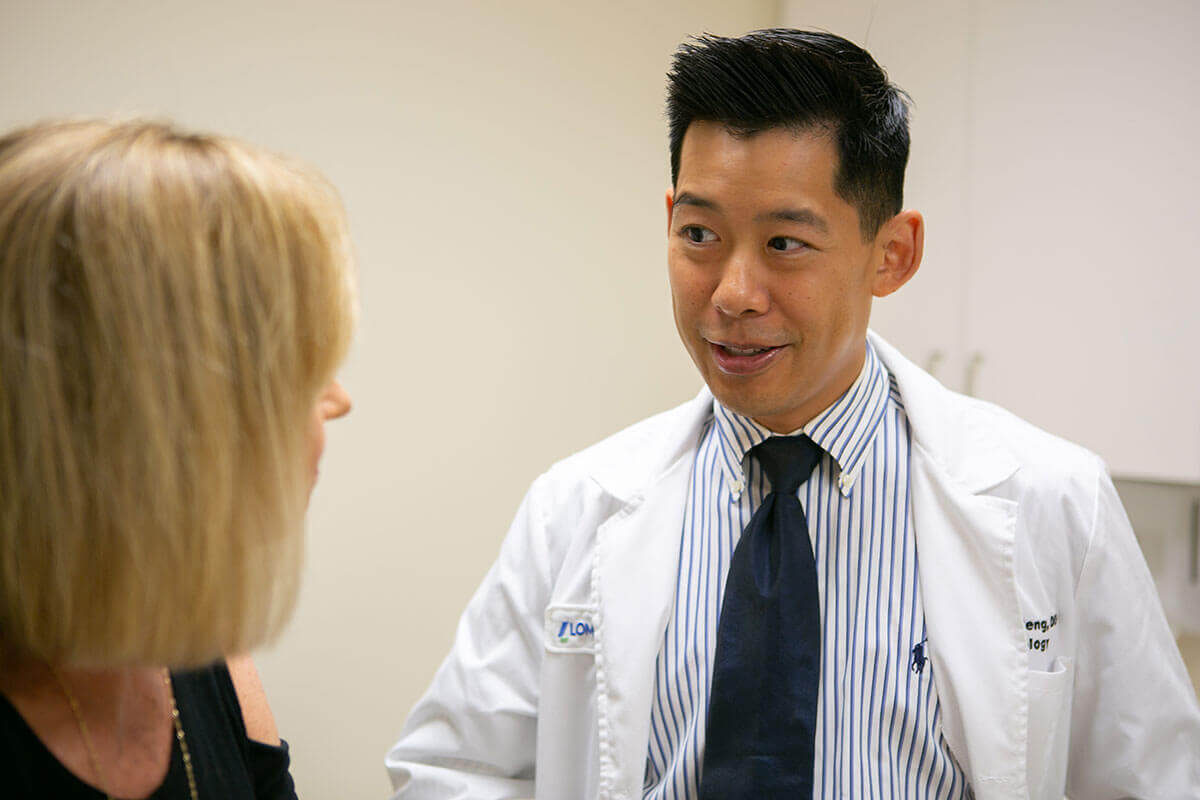 Dr. Peng speaking to Gayle during an exam.